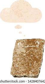 cartoon biscuit with thought bubble in grunge distressed retro textured style
