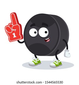 cartoon black rubber hockey puck character mascot with the number 1 one sports fan hand glove on a white background
