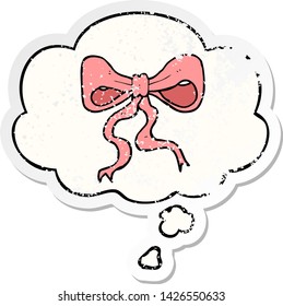 cartoon bow with thought bubble as a distressed worn sticker