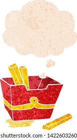 cartoon box of fries with thought bubble in grunge distressed retro textured style