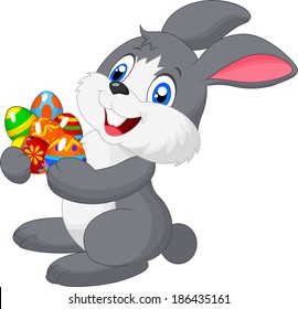 Cartoon bunny holding decorated egg