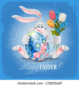 Cartoon bunny holding painted Easter egg and spring flowers and wishes you a Happy Easter