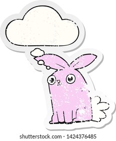 cartoon bunny rabbit with thought bubble as a distressed worn sticker