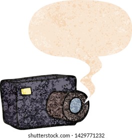 cartoon camera with speech bubble in grunge distressed retro textured style