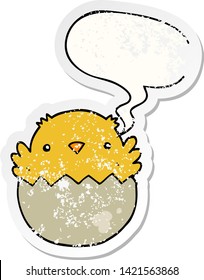 cartoon chick hatching from egg with speech bubble distressed distressed old sticker