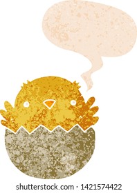 cartoon chick hatching from egg with speech bubble in grunge distressed retro textured style