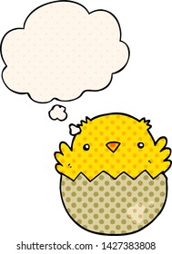 cartoon chick hatching from egg with thought bubble in comic book style