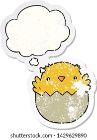 cartoon chick hatching from egg with thought bubble as a distressed worn sticker