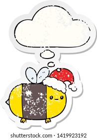 cartoon christmas bee with thought bubble as a distressed worn sticker