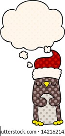 cartoon christmas penguin with thought bubble in comic book style
