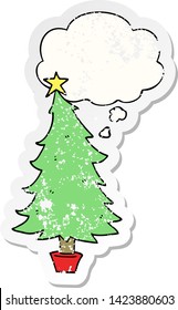 cartoon christmas tree with thought bubble as a distressed worn sticker