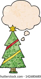 cartoon christmas tree with thought bubble in grunge texture style