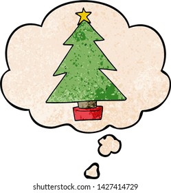 cartoon christmas tree with thought bubble in grunge texture style