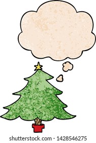 cartoon christmas tree with thought bubble in grunge texture style