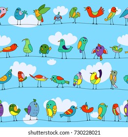 Cartoon colorful flock of funny little birds sitting on wires. Funny characters. Color seamless pattern. Background of clouds in the sky.