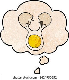 cartoon cracked egg with thought bubble in grunge texture style