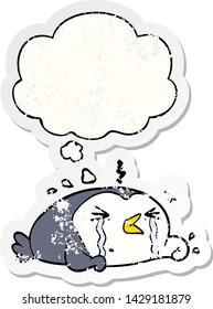 cartoon crying penguin with thought bubble as a distressed worn sticker