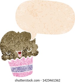 cartoon cupcake with face with speech bubble in grunge distressed retro textured style