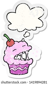 cartoon cupcake with thought bubble as a distressed worn sticker