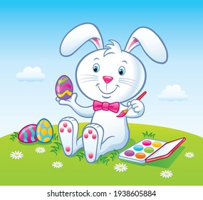 Cartoon of a cute bunny rabbit with a pink bowtie that is painting colorful Easter eggs atop a grassy hilltop with a paint set on a beautiful day.