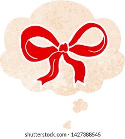 cartoon decorative bow with thought bubble in grunge distressed retro textured style