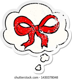 cartoon decorative bow with thought bubble as a distressed worn sticker