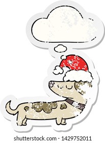 cartoon dog wearing christmas hat with thought bubble as a distressed worn sticker