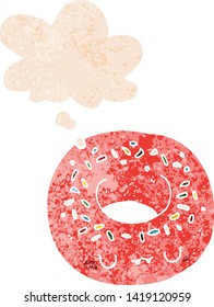 cartoon donut with thought bubble in grunge distressed retro textured style