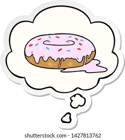 cartoon donut with thought bubble as a printed sticker