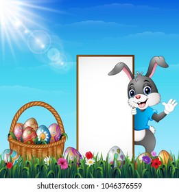 Cartoon Easter bunny with a basket of easter eggs and blank sign in the grass field