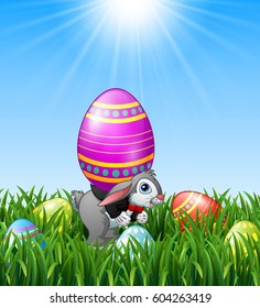 Cartoon easter bunny carrying easter eggs in the grass background.Vector illustration