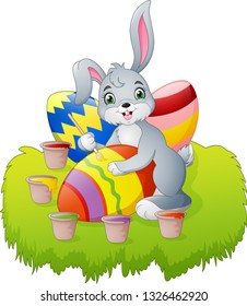Cartoon Easter bunny painting an egg