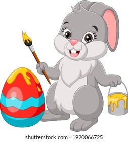 Cartoon easter bunny painting an egg