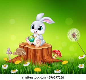 Cartoon Easter Bunny painting an egg on tree stump in summer season background