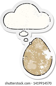 cartoon egg with thought bubble as a distressed worn sticker