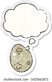 cartoon egg with thought bubble as a distressed worn sticker