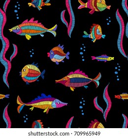 Cartoon embroidered fish on a black background - seamless pattern. Prints for textiles. Handmade. Vector illustration.