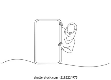 Cartoon of excited asian muslim lady peeking out big giant vertical smartphone with white blank screen presenting device display. One line art
