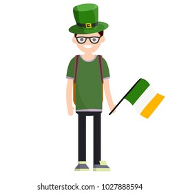 Cartoon flat illustration- a young nerd guy in green clothes and a hat stands with a flag. celebration of St. Patrick's. One man with a backpack.
