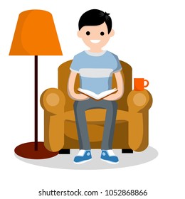 Cartoon flat illustration - a young smart guy in a t-shirt reads a book in a soft chair. room with furniture and a lamp for lighting. interesting leisure and recreation. the education at home.
