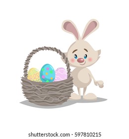 Cartoon funny easter bunny with big basket and painted colorful eggs. Spring character mascot and seasonal vector illustration.
