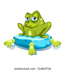 Cartoon green frog character sitting on a blue pillow