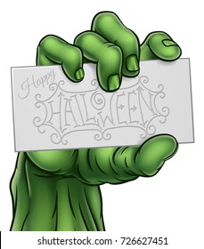 A cartoon green zombie monster claw hand holding Happy Halloween sign