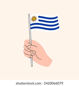 Cartoon Hand Holding Uruguayan Flag, Simple Vector Design. Flag of Uruguay, South America Concept Illustration, Isolated Flat Drawing