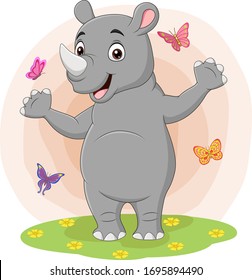 Cartoon happy rhino with butterflies in the grass