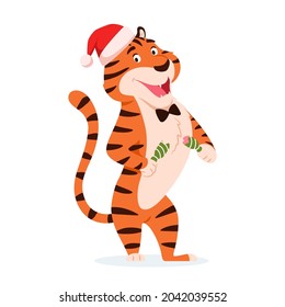 Cartoon happy tiger in Santa hat with Christmas cracker isolated on white background. Cute smiling wild cat. Chinese symbol of New Year 2022. Holiday surprise. Striped character vector illustration.