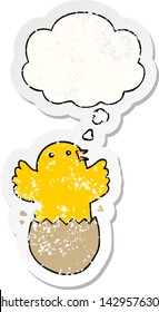 cartoon hatching bird with thought bubble as a distressed worn sticker