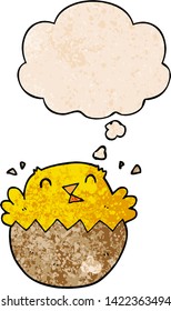 cartoon hatching chick with thought bubble in grunge texture style