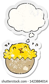 cartoon hatching chick with thought bubble as a distressed worn sticker