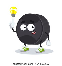 cartoon have an idea black rubber hockey puck mascot on white background